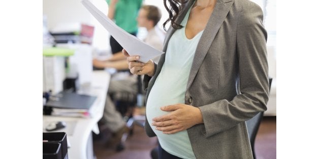 Pregnant businesswoman working in office