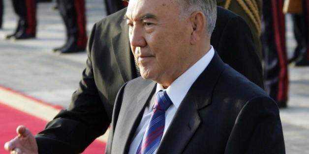 Syrian President Bashar al-Assad (behind) shows the way to Kazakh President Nursultan Nazarbaev (front) after reviewing the h