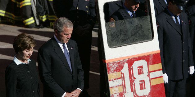 President George W. Bush and the first lady, Laura Bush, bow their heads for a moment of silence during a ceremony at the Fort Pitt Firehouse on the lower east side of Manhattan during a ceremony remembering those lost in the 9/11 terrorist attacks, Monday, Sept. 11, 2006 in New York. (AP Photo/Julie Jacobson)