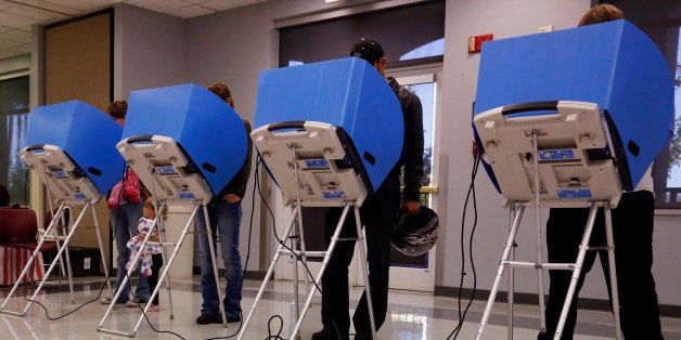 Adams County, Colorado voters casts their vote at a polling place in the Thornton Recreation Center, Tuesday, Nov. 4, 2014, in Thornton, Colo. (AP Photo/Jack Dempsey)