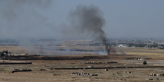 Smoke rises near an Afghan military base during fighting between Taliban militants and Afghan security forces in Kunduz on Oc