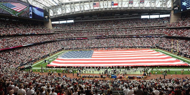 HOUSTON, TX - SEPTEMBER 13: A large American flag is stretched across the field for the National Anthem before the Houston Texans play the Kansas City Chiefs in the second quarter in a NFL game on September 13, 2015 at NRG Stadium in Houston, Texas. (Photo by Thomas B. Shea/Getty Images)