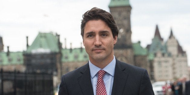 Canadian Liberal Party leader Justin Trudeau walks from the parliament to give a press conference in Ottawa on October 20, 20