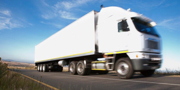 Semi-truck driving on remote road