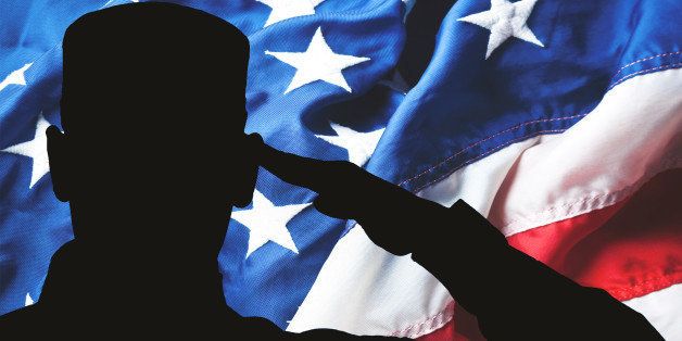 Proud saluting male army soldier on american flag background (Memorial day, Veteran's day, 4th of july, Independence day)