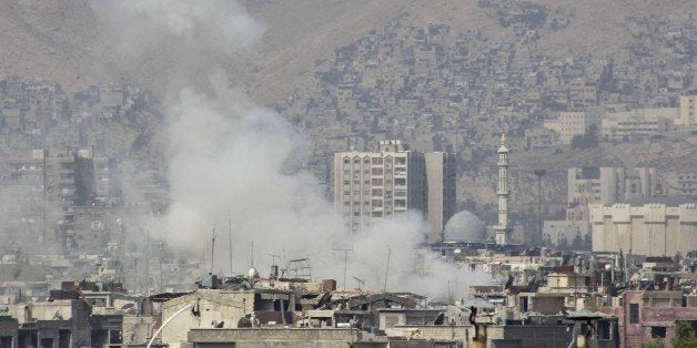 DAMASCUS, SYRIA - OCTOBER 26: Smoke rises after Assad regime forces' air strikes over the residential areas in Ayn Tarma town