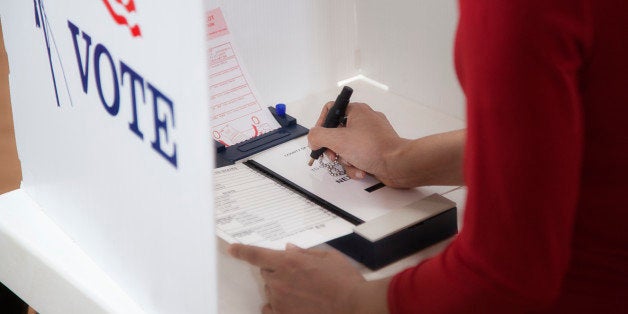 Asian voter voting in polling place