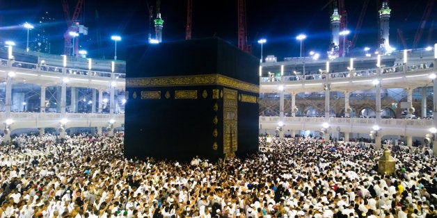 Picture of the Kaaba and a group of pilgrims they walk around to perform Hajj or Umrah, and all Muslims follow its, Located in Mecca in Saudi Arabia.