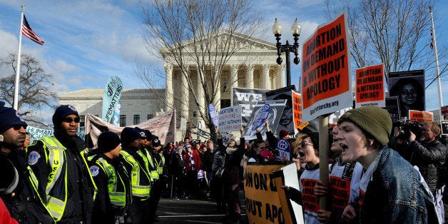 WASHINGTON, DC - JAN 22: There were heated exchanges between (R) pro-choice (pictured) rally goers and anti-abortion protestors in front of the Supreme Court. The police stepped in to keep them apart and some of the pro-choice activists were arrested.Thousands of anti-abortion protestors rallied on the mall and marched (up Constitution Ave.) the Supreme Court to show their displeasure with the Roe V Wade decision. (Photo by Michael S. Williamson/The Washington Post via Getty Images