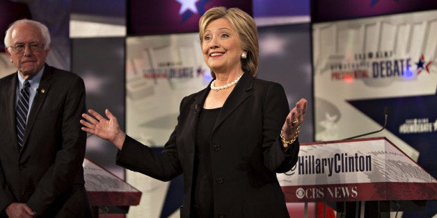 Democratic presidential candidates Hillary Clinton, former Secretary of State, right, gestures as Senator Bernie Sanders, an independent from Vermont, stands on stage at the start of the Democratic presidential candidate debate at Drake University in Des Moines, Iowa, U.S., on Saturday, Nov. 14, 2015. The second Democratic debate, hosted by CBS News, KCCI and the Des Moines Register, is the Democratic National Committee's only sanctioned debate in Iowa prior to the states first-in-the-nation caucuses on Feb. 1. Photographer: Daniel Acker/Bloomberg via Getty Images 