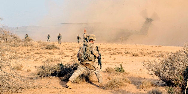 Sgt. Kevin Fischer, Sight Security Team 1st Battalion 161st Field Artillery, signals his security team to fill in the security perimeter, August 22, in the deserts of Djibouti. U.S. Army photo by Specialist Michelle C. Lawrence