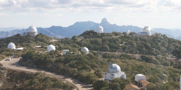 Kitt Peak National Observatory, Arizona - A field of telescopes dots the summit of Kitt Peak, on the Tohono Oodham First Nation reservation in Sells, Ariz. The 7,730-foot peak of Baboquivari is visible in the background. (John Briley/For The Washington Post via Getty Images)