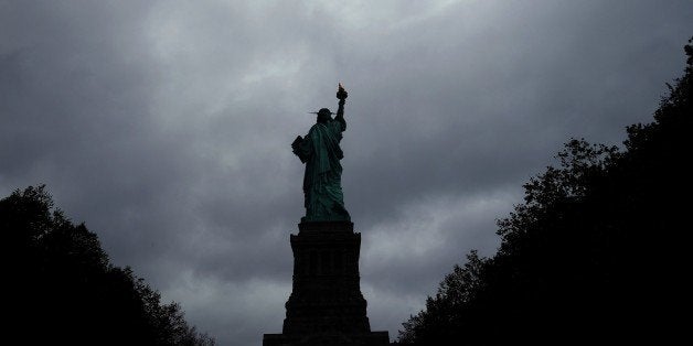 The Statue of Liberty stands tall as cloud hover over it in New York on October 3, 2015. AFP PHOTO/JEWEL SAMAD (Photo