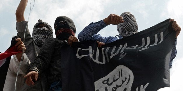 Kashmiri demonstrators hold up a flag of the Islamic State of Iraq and the Levant (ISIL) during a demonstration against Israeli military operations in Gaza, in downtown Srinagar on July 18, 2014. The death toll in Gaza hit 265 as Israel pressed a ground offensive on the 11th day of an assault aimed at stamping out rocket fire, medics said. AFP PHOTO/Tauseef MUSTAFA (Photo credit should read TAUSEEF MUSTAFA/AFP/Getty Images)