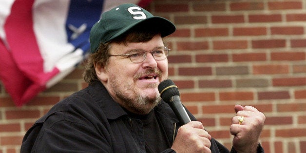 BOSTON - JULY 27: Filmmaker Michael Moore addresses a crowd of people who couldn't get inside a packed 'Take America Back' conference at the Royal Sonesta Hotel in Boston, Massachusetts. Moore was in Boston to appear at several events during the Democratic National Convention. (Photo by Michael Springer/Getty Images)