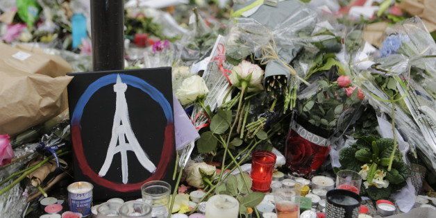 LE PETIT CAMBODGE, PARIS, ÃLE-DE-FRANCE, FRANCE - 2015/11/17: A painted peace sign with the Eiffel Tower in it has been placed at the memorial outside the restaurant Le Petit Cambodge for the people killed here during the Paris attacks. Parisians and tourists continue to visit the memorials for the people killed in the terrorists attacks in Paris, to lay down flowers and candles and to pay their respect. Over 130 people have been by terrorist from the Islamic State. (Photo by Michael Debets/Pacific Press/LightRocket via Getty Images)