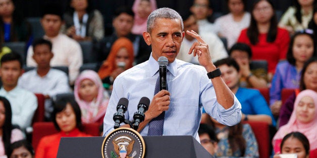 U.S. President Barack Obama gestures as he speaks at the Young Southeast Asian Leaders Initiative (YSEALI) during a town hall meeting at Taylor's University in Kuala Lumpur, Malaysia, Friday, Nov. 20, 2015. Obama urged young people in predominantly Muslim Malaysia on Friday to reject the âterrible visionâ that drove the Paris attacks, offering an alternative vision in which traditional cultures coexist with a diverse modern world. (AP Photo/Vincent Thian)