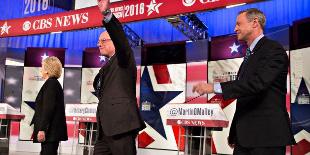 Democratic presidential candidates Hillary Clinton, former Secretary of State, left, Senator Bernie Sanders, an independent from Vermont, center, and Martin OMalley, former governor of Maryland, arrive on stage at the start of the Democratic presidential candidate debate at Drake University in Des Moines, Iowa, U.S., on Saturday, Nov. 14, 2015. The second Democratic debate, hosted by CBS News, KCCI and the Des Moines Register, is the Democratic National Committee's only sanctioned debate in Iowa prior to the states first-in-the-nation caucuses on Feb. 1. Photographer: Daniel Acker/Bloomberg via Getty Images 