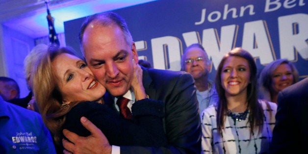 Louisiana Gov.-elect John Bel Edwards hugs his wife Donna Edwards as he arrives to greet supporters at his election night watch party in New Orleans, Saturday, Nov. 21, 2015. Right is his daughter Sarah Ellen Edwards. John Bel Edwards won the runoff election for Louisiana governor Saturday, defeating the once-heavy favorite, Republican David Vitter, and handing the Democrats their first statewide victory since 2008. (AP Photo/Gerald Herbert)