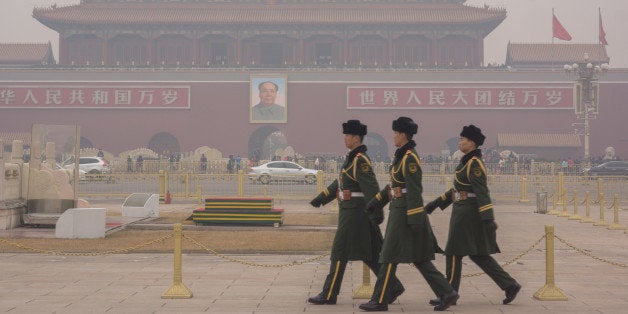 BEIJING, CHINA - 2015/01/16: Guard soldiers walk on Tiananmen square in the heavy haze. This is the first Yellow warning of Beijing's air pollution in 2015 and the hazy weather will last a few days. (Photo by Zhang Peng/LightRocket via Getty Images)