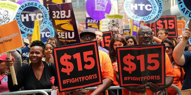 NEW YORK, NY - JULY 22: Labor leaders, workers and activists attend a rally for a $15 minimum hourly wage on July 22, 2015 in New York City. A panel appointed by Governor Andrew Cuomo recommended on Wednesday that the minimum wage be raised for employees of fast-food chain restaurants throughout the state. The panel recommended that the $15 rate be phased in by December 31, 2018 for New York City and by July 1, 2021 for the rest of the state. (Photo by Spencer Platt/Getty Images)