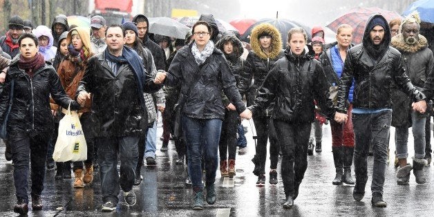 People take part in a memorial march in Berlin, on November 15, 2015 for the victims of the deadly attacks in and around Pari