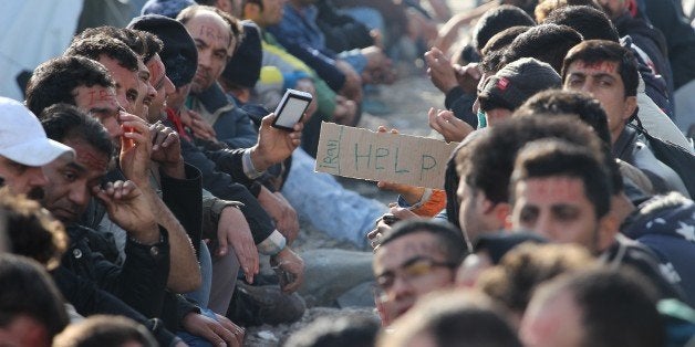 GEVGELIJA, MACEDONIA - NOVEMBER 24: Refugees stage a protest against governments' double standards over refugee admittance policies, other than Syrians, as they wait at Macedonia- Greek border in Gevgelija, Macedonia on November 24, 2015. (Photo by Ilin Nikolovski/Anadolu Agency/Getty Images)