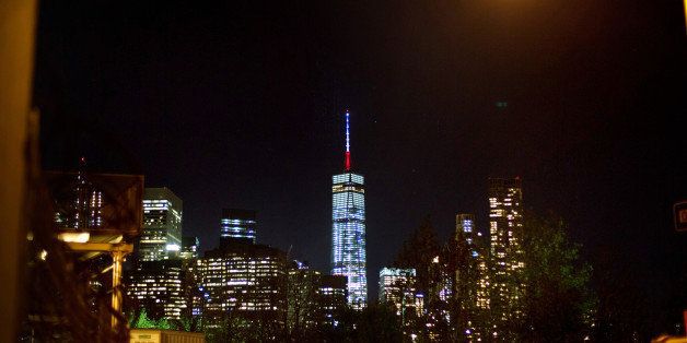 The One World Trade Center spire is lit blue, white and red after New York Gov. Andrew Cuomo announced the lighting in honor of dozens killed in the Paris attacks Friday, Nov. 13, 2015, in New York. French officials say several dozen people have been killed in shootings and explosions at a theater, restaurant and elsewhere in Paris. (AP Photo/Kevin Hagen)