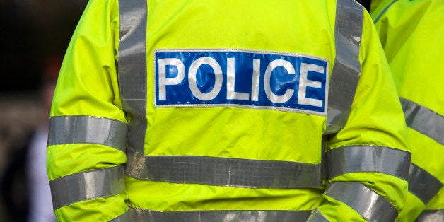 Shot of the back of a police officer's jacket with the word police written across the back