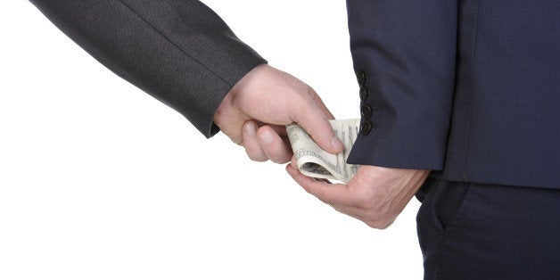 Man gently takes a bribe isolated on white background