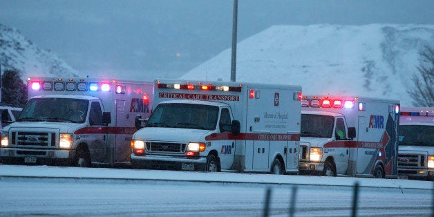 Ambulances wait to be directed near intersection of Centennial and Fillmore near a Planned Parenthood clinic Friday, Nov. 27,