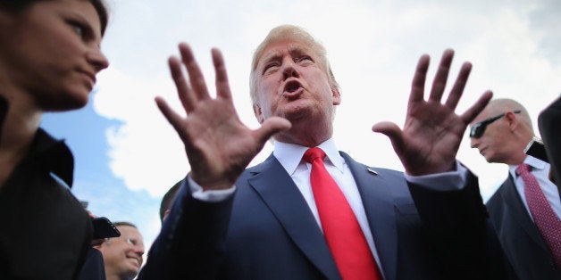 WASHINGTON, DC - SEPTEMBER 09: Republican presidential candidate Donald Trump (2nd L) talks with journalists during a rally against the Iran nuclear deal on the West Lawn of the U.S. Capitol September 9, 2015 in Washington, DC. Thousands of people gathered for the rally, organized by the Tea Party Patriots, which featured conservative pundits and politicians. (Photo by Chip Somodevilla/Getty Images)