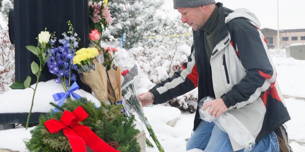 COLORADO SPRINGS, CO - NOVEMBER 28: Roy Kieffer lays flowers on a memorial at Fillmore Street and Centennial Boulevard on Nov