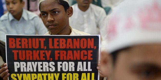 Indian Muslim students hold posters during a gathering to denounce the Islamic State, in Mumbai on November 20, 2015. Islamic State jihadists claimed a series of coordinated attacks by gunmen and suicide bombers in Paris on November 13, that killed at least 129 people in scenes of carnage at a concert hall, restaurants and the national stadium. AFP PHOTO/ Indranil MUKHERJEE (Photo credit should read INDRANIL MUKHERJEE/AFP/Getty Images)