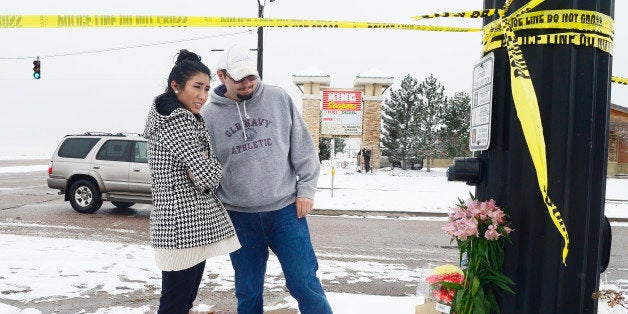 COLORADO SPRINGS, CO - NOVEMBER 28: Justina Apodaca and Dylan Watson look a the memorial after laying flowers on the corner o