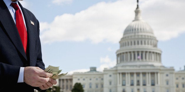 A politician counting money in front of the US Capitol Building