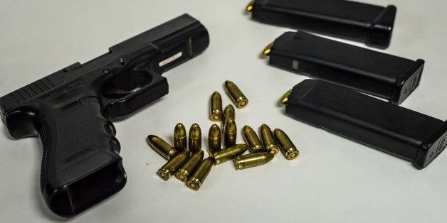 A standard gun and unmarked bullets, made by Cavim and issued to police officers, are arranged for a photograph in Caracas, Venezuela, on Thursday, March 12, 2015. The Venezuelan military's failure to comply with bullet coding laws is fueling the world's second-highest murder rate and enriching black market speculators, according to lawmakers, police officers and activists. Photographer: Meridith Kohut/Bloomberg via Getty Images