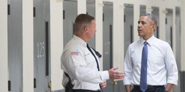 US President Barack Obama, alongside Ronald Warlick (L), a correctional officer, tours a cell block at the El Reno Federal Correctional Institution in El Reno, Oklahoma, July 16, 2015. Obama is the first sitting US President to visit a federal prison, in a push to reform one of the most expensive and crowded prison systems in the world. AFP PHOTO / SAUL LOEB (Photo credit should read SAUL LOEB/AFP/Getty Images)