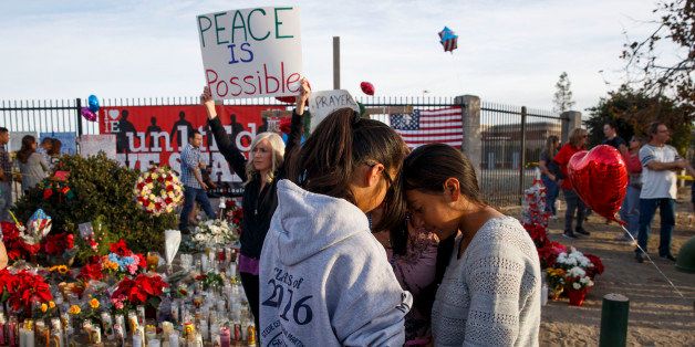 People gather at a makeshift memorial near the Inland Regional Center during the aftermath of a mass shooting that killed 14 people on Sunday, December 6, 2015 in San Bernardino, California, USA. AFP PHOTO/PATRICK T. FALLON / AFP / Patrick T. Fallon (Photo credit should read PATRICK T. FALLON/AFP/Getty Images)