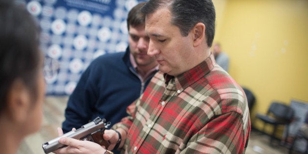 JOHNSTON, IA - DECEMBER 04: Republican presidential candidate Sen. Ted Cruz (R-TX) looks over a handgun handed to him by a s