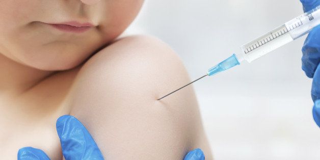 Boy and vaccine syringe