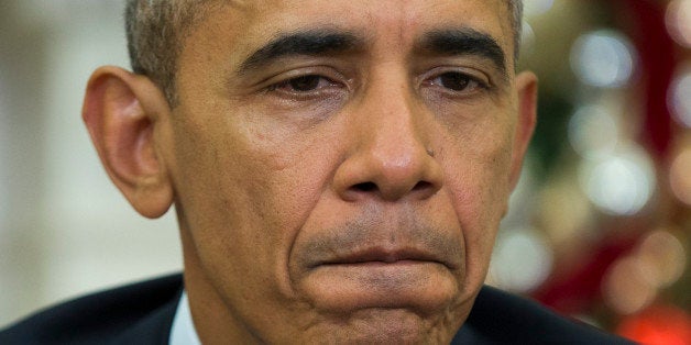 President Barack Obama pauses while making a statement on Wednesday's mass shooting in San Bernardino, Calif., Thursday, Dec. 3, 2015, in the Oval Office of the White House in Washington. (AP Photo/Evan Vucci)