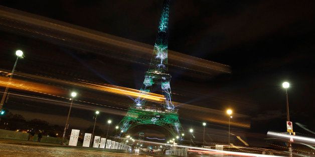 An artwork entitled 'One Heart One Tree' by artist Naziha Mestaoui is displayed on the Eiffel tower as part of the COP21, United Nations Climate Change Conference, Monday, Nov. 30, 2015. (AP Photo/Laurent Cipriani)