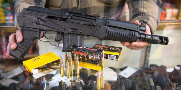 TINLEY PARK, IL - FEBRUARY 27: Green tipped armor-piercing 5.56 millimeter ammunition and an AK-47 pistol that shoots the round are offered for sale at Freddie Bear Sports on February 27, 2015 in Tinley Park, Illinois. The Obama administration has proposed banning the ammunition, which is popular among hunters and target shooters, because it can be used in pistols. Fear of a ban has caused a run on sales. (Photo Illustration by Scott Olson/Getty Images)