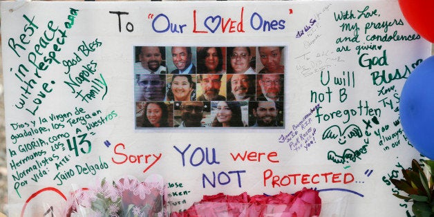 SAN BERNARDINO, CA - DECEMBER 9: The photos of the 14 people who were killed in the mass shooting last week at the Inland Regional Center are remembered on a poster at the roadside memorial on the corner of Waterman Avenue and Orange Show Road in San Bernardino December 9, 2015 December 9, 2015 (Photo by Mark Boster/Los Angeles Times via Getty Images)