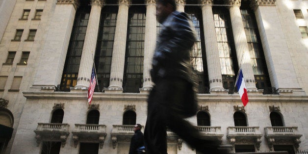 NEW YORK, NY - NOVEMBER 23: People walk outside of the New York Stock Exchange (NYSE) during morning trading on November 23, 2015 in New York City. Following a week of strong gains on Wall Street, markets were down in morning trading. (Photo by Spencer Platt/Getty Images)