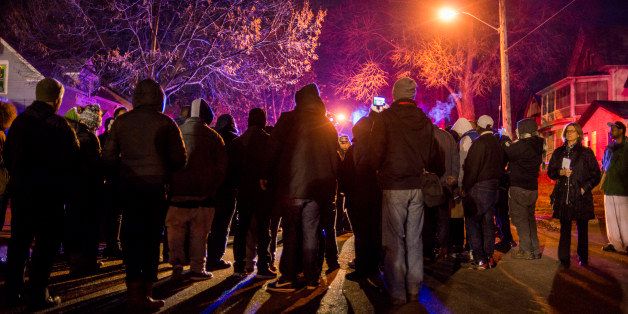 MINNEAPOLIS, MN - NOVEMBER 24: A group gathers in front of a police line after 5 people were shot at a Black Lives Matters protest November 24, 2015 in Minneapolis, Minnesota. According to reports, a group of white men allegedly opened fire on the crowd after being escorted away from the encampment. (Photo by Stephen Maturen/Getty Images)