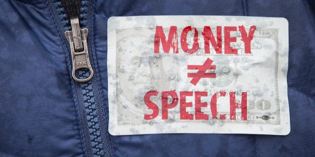 WASHINGTON, DC - JANUARY 21: An attendee wears a sticker against money in politics during a rally calling for an end to corpo