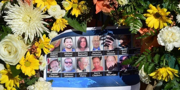 The deceased are remembered with their pictures on a sheet placed within a wreath at a makeshift shrine near the scene of the shootings five days ago on December 7, 2015 in San Bernardino, California. AFP PHOTO / FREDERIC J. BROWN / AFP / FREDERIC J. BROWN (Photo credit should read FREDERIC J. BROWN/AFP/Getty Images)