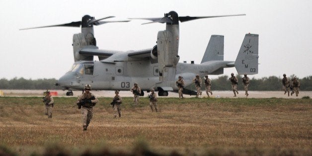 A V-22 Osprey and marines perform a demonstration during the visit of US Secretary of Defense and Spanish Defence Minister to the US marines base in Moron de la Frontera October 6, 2015. Carter's is on a five day European trip aimed at thanking allies from the US-led coalition that is carrying out daily drone and plane strikes against IS in Iraq and Syria. Spain has agreed to the establishment of a permanent force of 2,200 US marines to intervene in Africa, at Moron de la Frontera site. AFP PHOTO / CRISTINA QUICLER (Photo credit should read CRISTINA QUICLER/AFP/Getty Images)